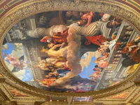 the ceiling of a building has a painting on it