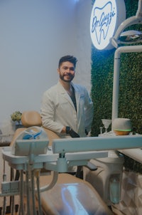 a man standing in front of a dental chair