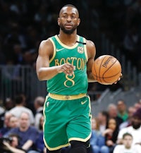 a boston celtics player dribbling a basketball