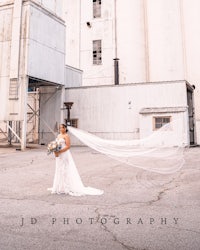 a bride standing in front of a grain elevator