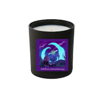 a candle with an image of a cat and a moon on it
