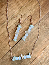 a pair of earrings and a necklace with white opalite stones