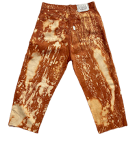 a pair of brown jeans with stains on them