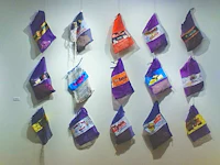 a group of purple and purple bags hanging on a wall