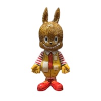 a toy bunny is wearing a yellow outfit