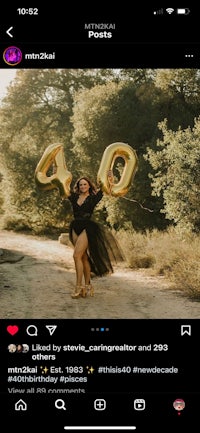 a woman in a black dress is holding a gold balloon