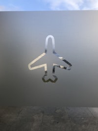 a silver airplane sticker on a glass window