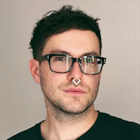 a man with glasses and a nose piercing