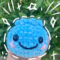 a blue stuffed animal with a smiley face