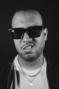 a black and white photo of a man wearing sunglasses