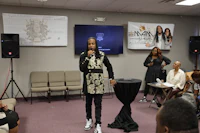 a woman standing in front of a group of people