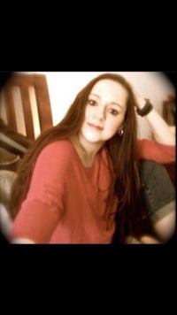 a girl with long hair is posing for a picture