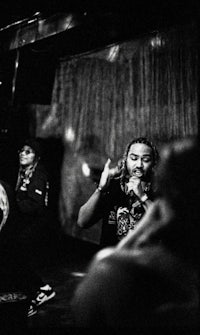 a black and white photo of a group of people in a dark room