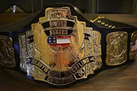 the wwe united states championship belt on a wooden table