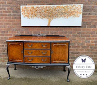 a sideboard with a tree painted on it