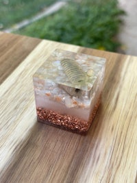 a small cube with a piece of sand on top of it