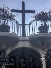a cross sits on top of a balcony