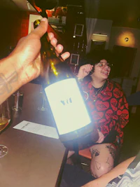 a man is holding a bottle of wine