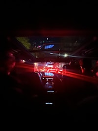 a red light shines through the window of a bus
