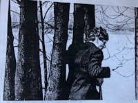 a black and white photograph of a man in the woods