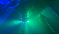 a blue and green light coming out of a dark room