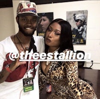 a man and woman posing for a photo in a leopard print outfit