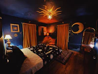 a bedroom with a moon and stars on the wall