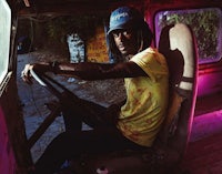 a man sitting in the driver's seat of a truck