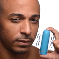 a man is holding a blue vibrating device