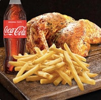 a chicken with fries and coca cola on a cutting board