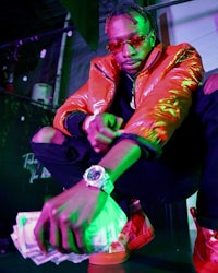 a man in a red jacket with money in his hands