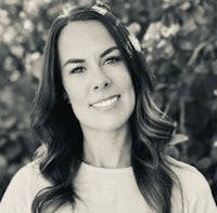 a black and white photo of a woman smiling