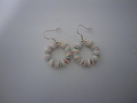 a pair of earrings on a white surface