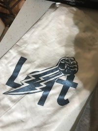 a white t - shirt with a lightning bolt on it