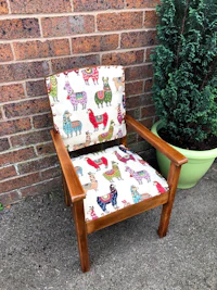 a wooden chair with a colorful llama print