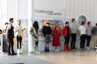 a group of people standing in front of a wall