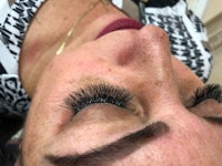 a woman with long lashes in a salon