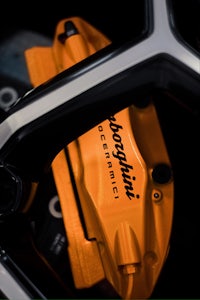 a close up of a motorcycle with orange brake calipers