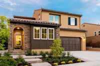 the exterior of a home with a garage and landscaping