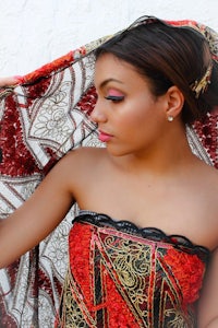 a woman wearing a red and black shawl