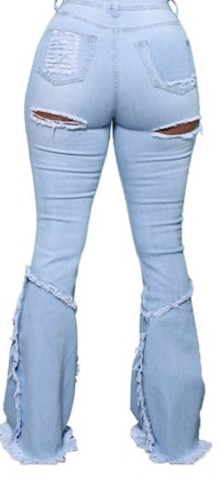 the back view of a woman wearing ripped jeans