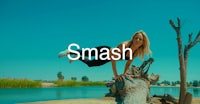 a woman doing a flip on a log with the word smash