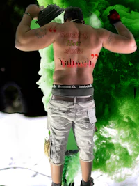 a man with a tattoo on his back with smoke coming out of his back