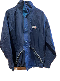 a blue jacket hanging on a wall