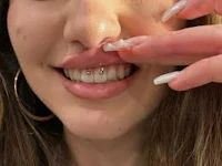 a woman with a piercing in her mouth