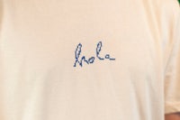 a man wearing a t - shirt with the word hola written on it