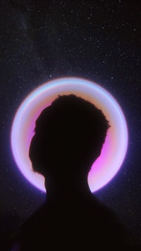 a silhouette of a person in front of a starry sky