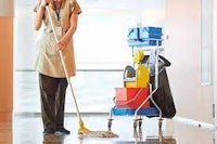 a woman cleaning a hallway with a mop