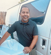 a man standing next to a white van