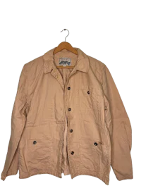 a tan jacket hanging on a hanger